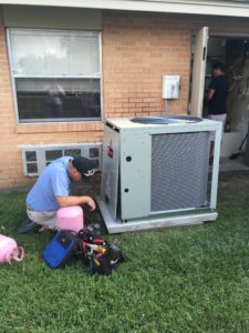 Contractor fixing outdoor AC unit