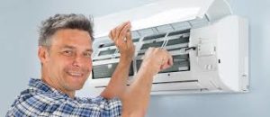 Man fixing indoor AC unit